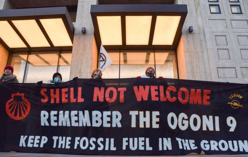 Protesters in London hold a 'Shell Not Welcome' banner referencing the Ogoni Nine