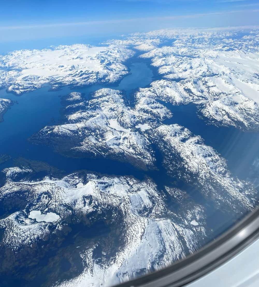 a stunning image of snow capped mountains from 30,000 feet above. View of Alaskan mountain range on approach into ANK airport a stunning image of snow capped mountains from 30,000 feet above. View of Alaskan mountain range on approach into ANK airport
