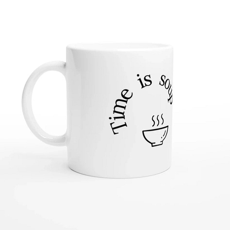 images of a mug from Nocturnal Narrator's website. The mug is white and the text is black, curled around the mug. There is a doodle of a bowl of soup and a fork
