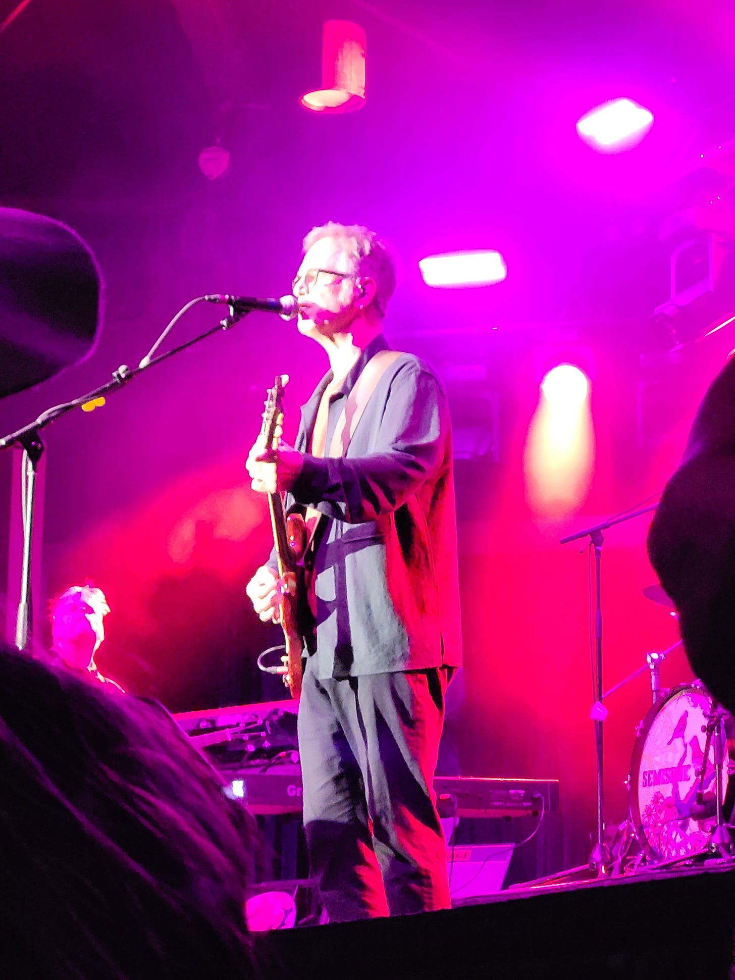 Dan Wilson, of Semisonic, singing, bathed in pink light, at the State Fair.