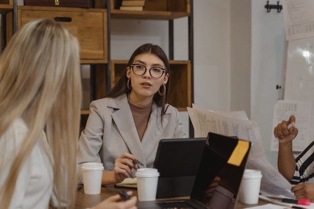 person in a business setting listening attentively to another