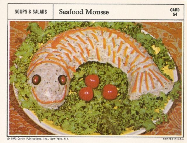 This may contain: a plate with some food on it and vegetables in the shape of an animal's head