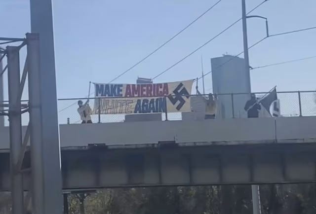 A group of people holding a banner

AI-generated content may be incorrect.