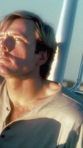 “Ceci n’est pas un selfie,” me and Midjourney. Blond magazine model stares up into the sunlight on a boat deck. Looks like an impromptu phone selfie, tilted toward the right, a sailboat mast in the background.