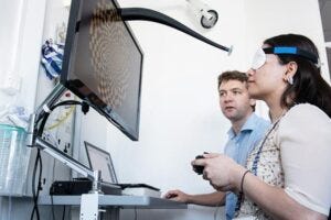 Dr Nick Cunniffe running a 'visual evoked potential' test with a trial participant in the Cambridge Clinical Vision Laboratory.
