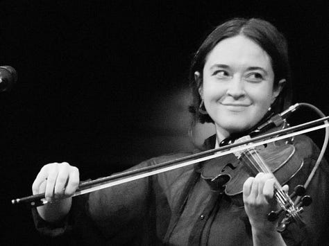 Black-and-white photos of each member of the Tweedy band performing live