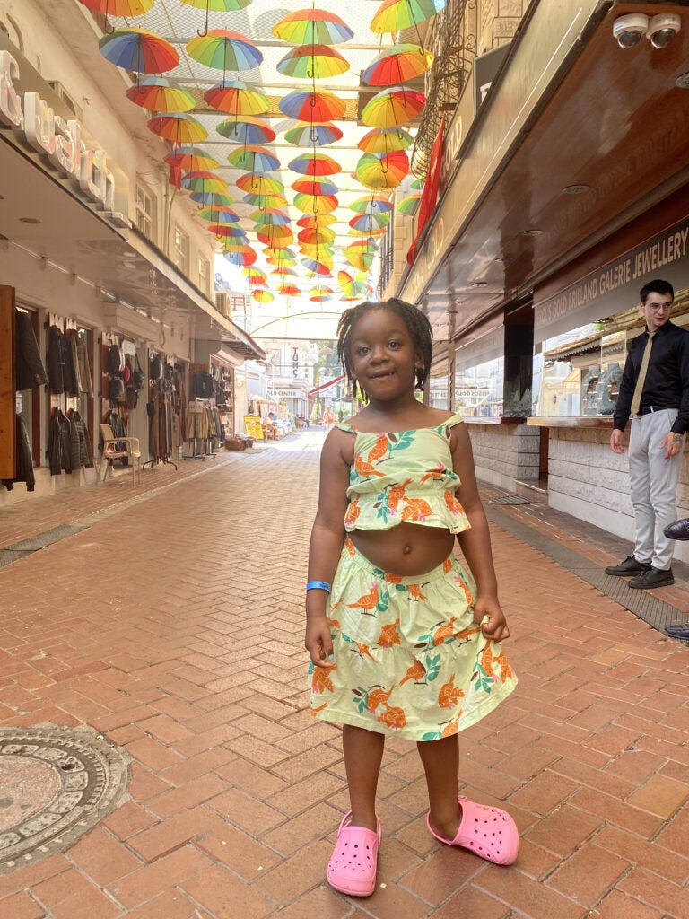 old town Fethiye Turkey Girl standing under umbrella installation