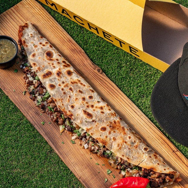 r/baseball - In terms of stadium food, the Marlins are now introducing "the machete", a two-foot long homemade flour tortilla griddled with melted mozzarella and Oaxaca cheeses, fritanga-style carne asada, guajillo pepper sauce, salsa verde and cilantro. Also comes in its very own carrying case. r/baseball - In terms of stadium food, the Marlins are now introducing "the machete", a two-foot long homemade flour tortilla griddled with melted mozzarella and Oaxaca cheeses, fritanga-style carne asada, guajillo pepper sauce, salsa verde and cilantro. Also comes in its very own carrying case.