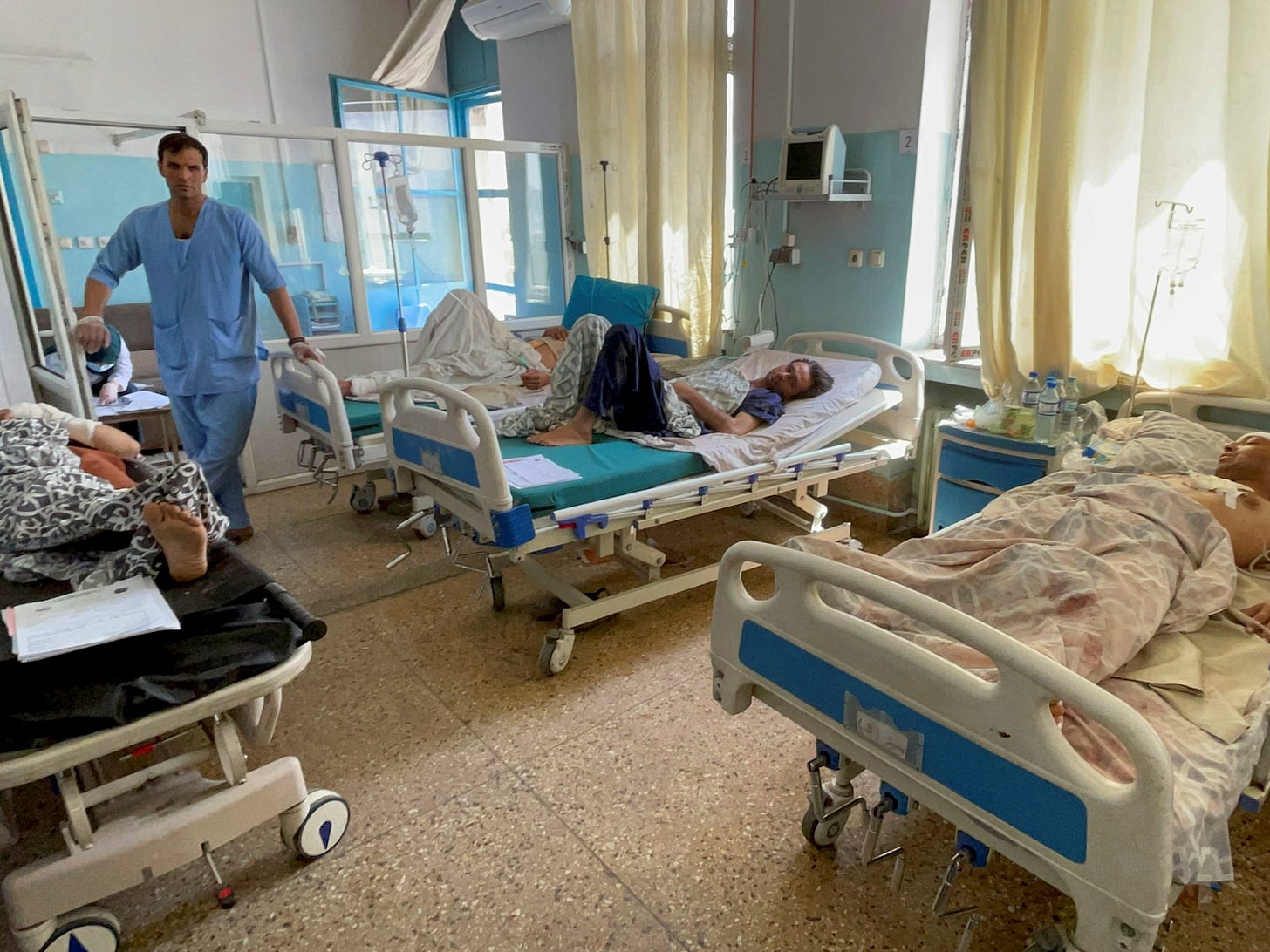 Afghan hospital room showing patients and limited healthcare resources amid ongoing crisis