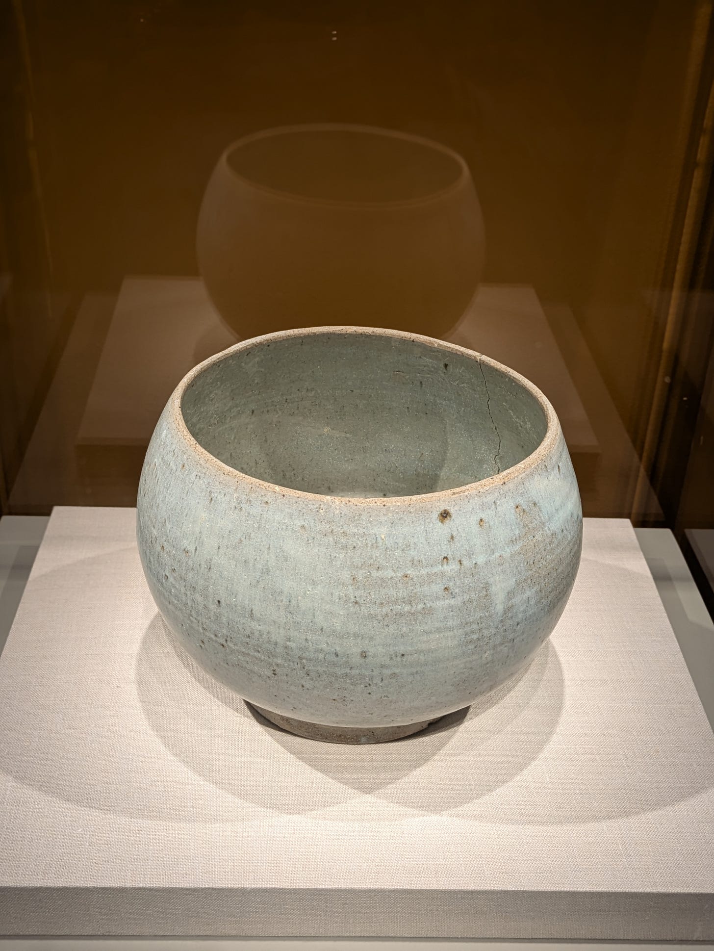 “Knowledge is Empty” Alms Bowl — North Central Thailand, late 15th–16th century. Humbly accepting food in an empty bowl is the beginning of one's journey to enlightenment in the Buddhist tradition. Stoneware with white glaze.