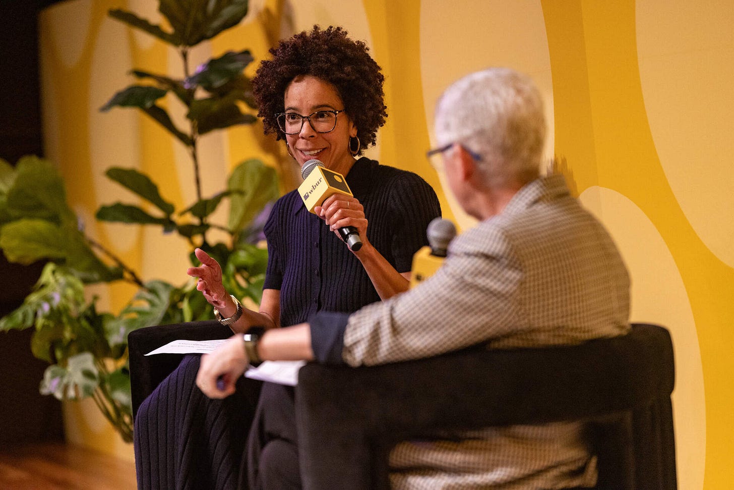 Ayana Elizabeth Johnson, a marine biologist and policy expert, speaks with Gina McCarthy, former White House climate advisor and EPA administrator, at The WBUR Festival. (Jesse Costa/WBUR)