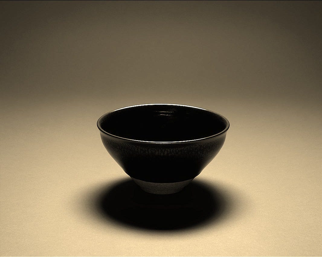 black ceramic bowl on white table