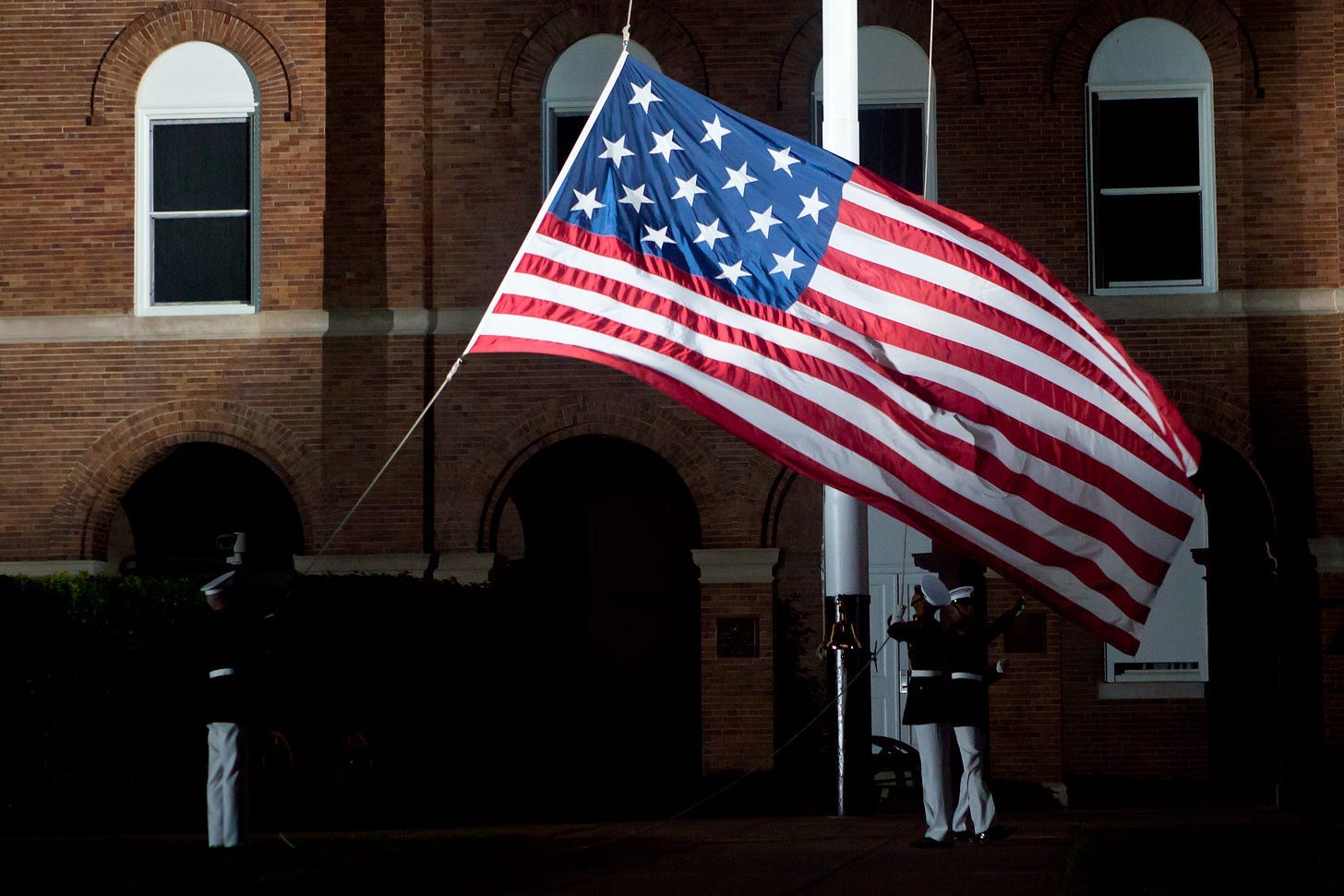 A picture containing building, flag of the united states, flag day (usa), window

Description automatically generated