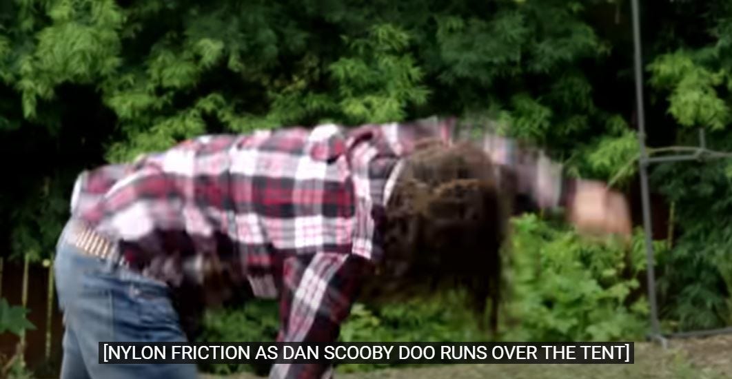Screenshot of Dan tripping over tent. Caption reads "nylon friction as Dan Scooby Doo runs over the tent.