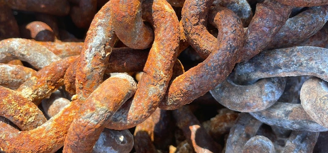 a pile of rusted metal chains sitting on top of each other