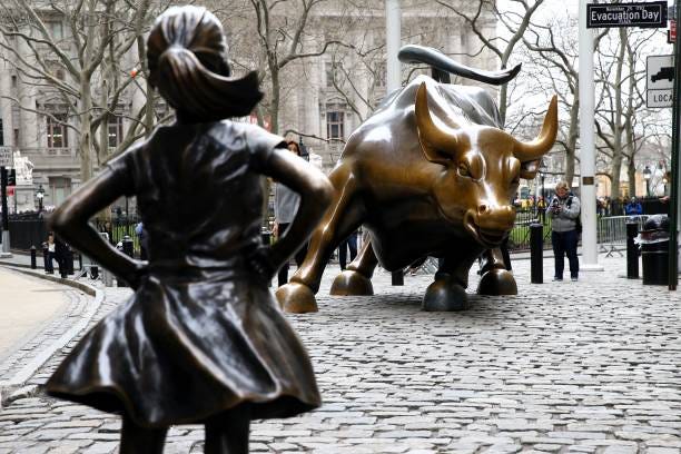 The "Fearless Girl" statue, a four-foot statue of a young girl, defiantly looks up the iconic "Charging Bull" sculpture The "Fearless Girl" statue, a four-foot statue of a young girl, defiantly looks up the iconic "Charging Bull" sculpture