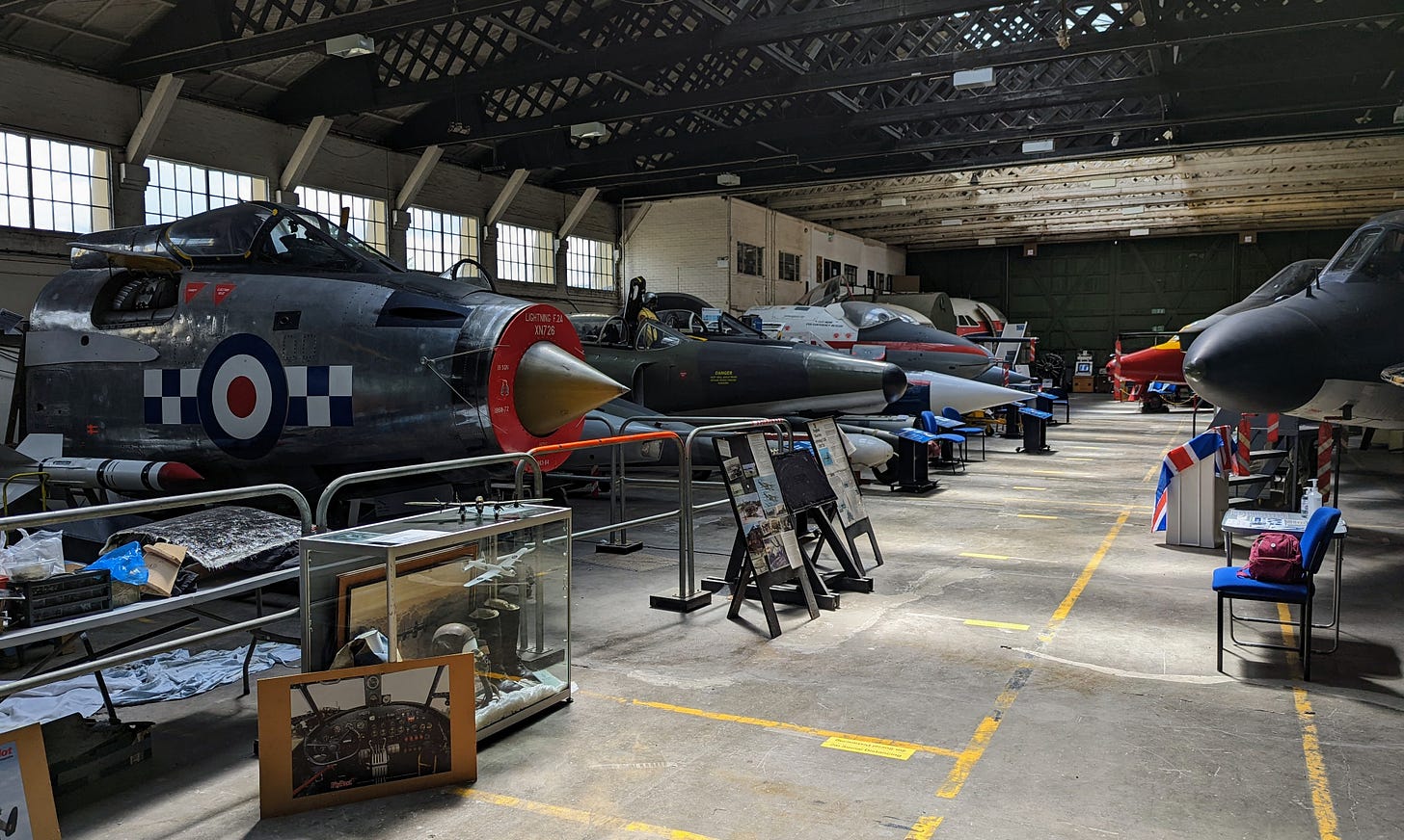Two rows of aircraft cockpits in a hangar