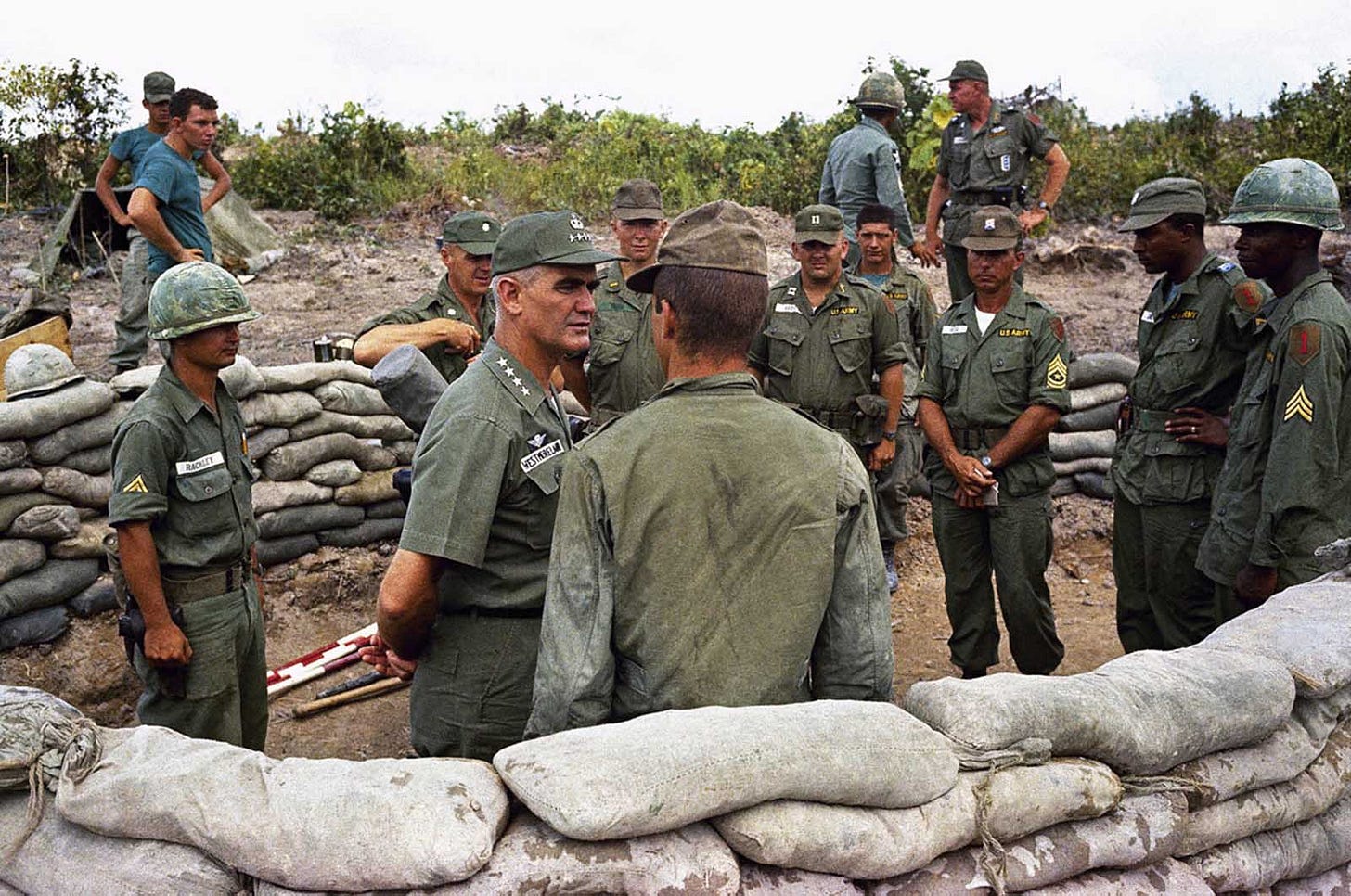 General William Westmoreland, commander of U.S. forces, converses with troops from the U.S. First Division near Bien Hoa, Vietnam, in 1965, during early stages of American ground engagement. General William Westmoreland, commander of U.S. forces, converses with troops from the U.S. First Division near Bien Hoa, Vietnam, in 1965, during early stages of American ground engagement.