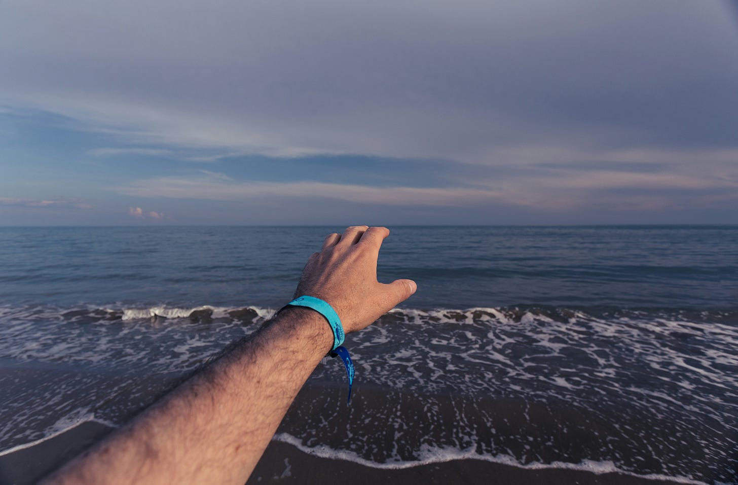 a person's arm reaching out over a far ocean horizon (search engines) a person's arm reaching out over a far ocean horizon (search engines)