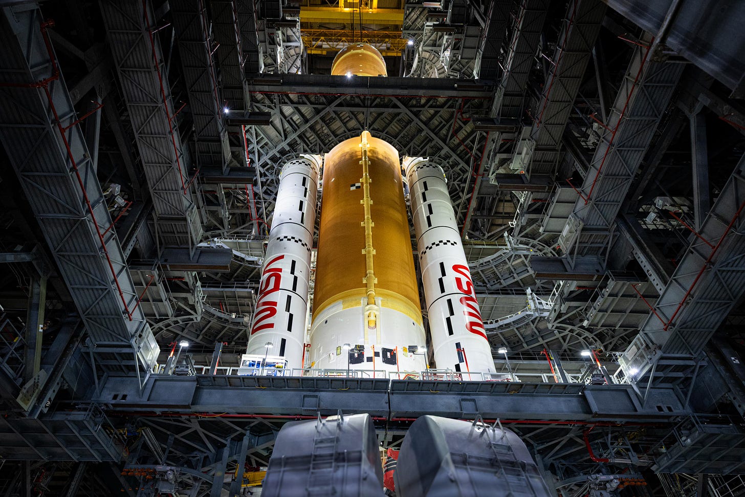 Teams with NASA’s Exploration Ground Systems and primary contractor Amentum, integrate the SLS (Space Launch System) Moon rocket with the solid rocket boosters onto mobile launcher 1 inside High Bay 3 of the Vehicle Assembly Building at NASA’s Kennedy Space Center on Sunday, March 23, 2025. Artemis II is the first crewed test flight under NASA’s Artemis campaign and is another step toward missions on the lunar surface and helping the agency prepare for future human missions to Mars. Photographer:NASA/Frank Michaux Teams with NASA’s Exploration Ground Systems and primary contractor Amentum, integrate the SLS (Space Launch System) Moon rocket with the solid rocket boosters onto mobile launcher 1 inside High Bay 3 of the Vehicle Assembly Building at NASA’s Kennedy Space Center on Sunday, March 23, 2025. Artemis II is the first crewed test flight under NASA’s Artemis campaign and is another step toward missions on the lunar surface and helping the agency prepare for future human missions to Mars. Photographer:NASA/Frank Michaux