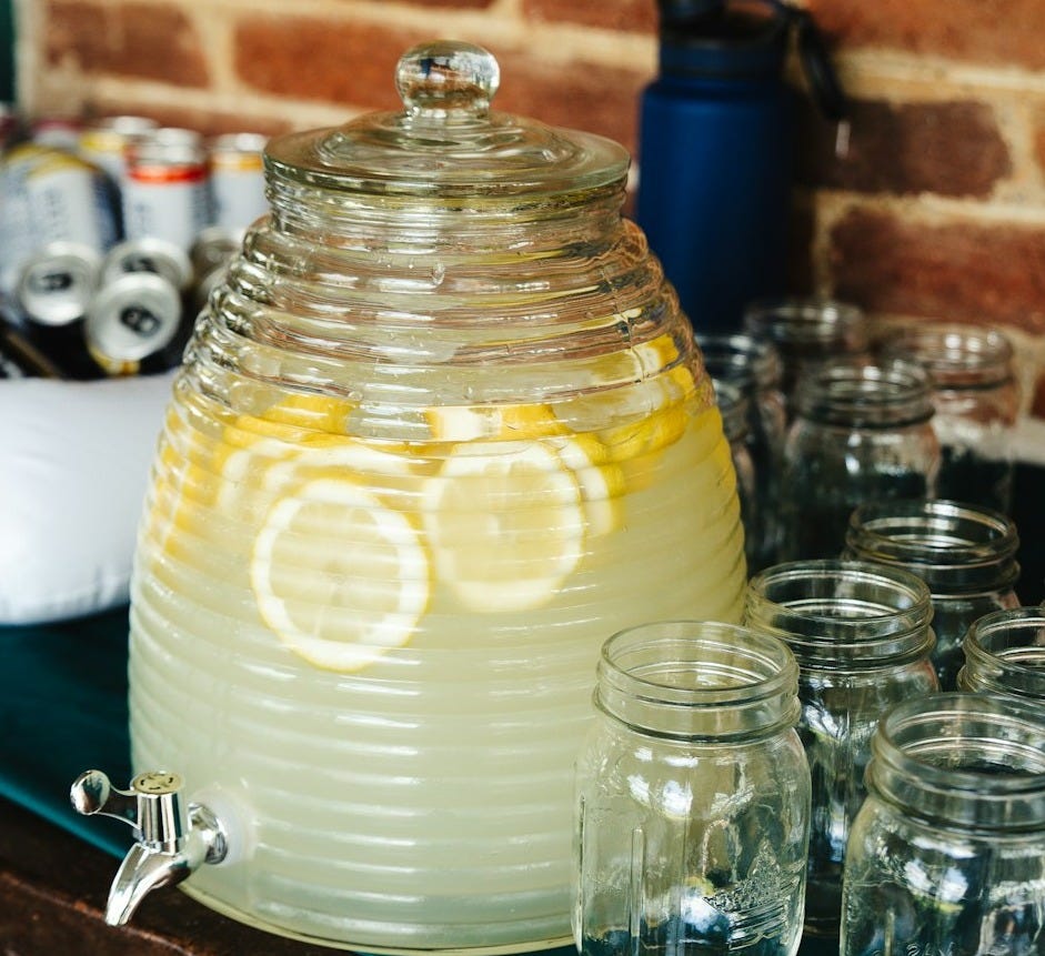 a pitcher of lemonade sitting on top of a counter