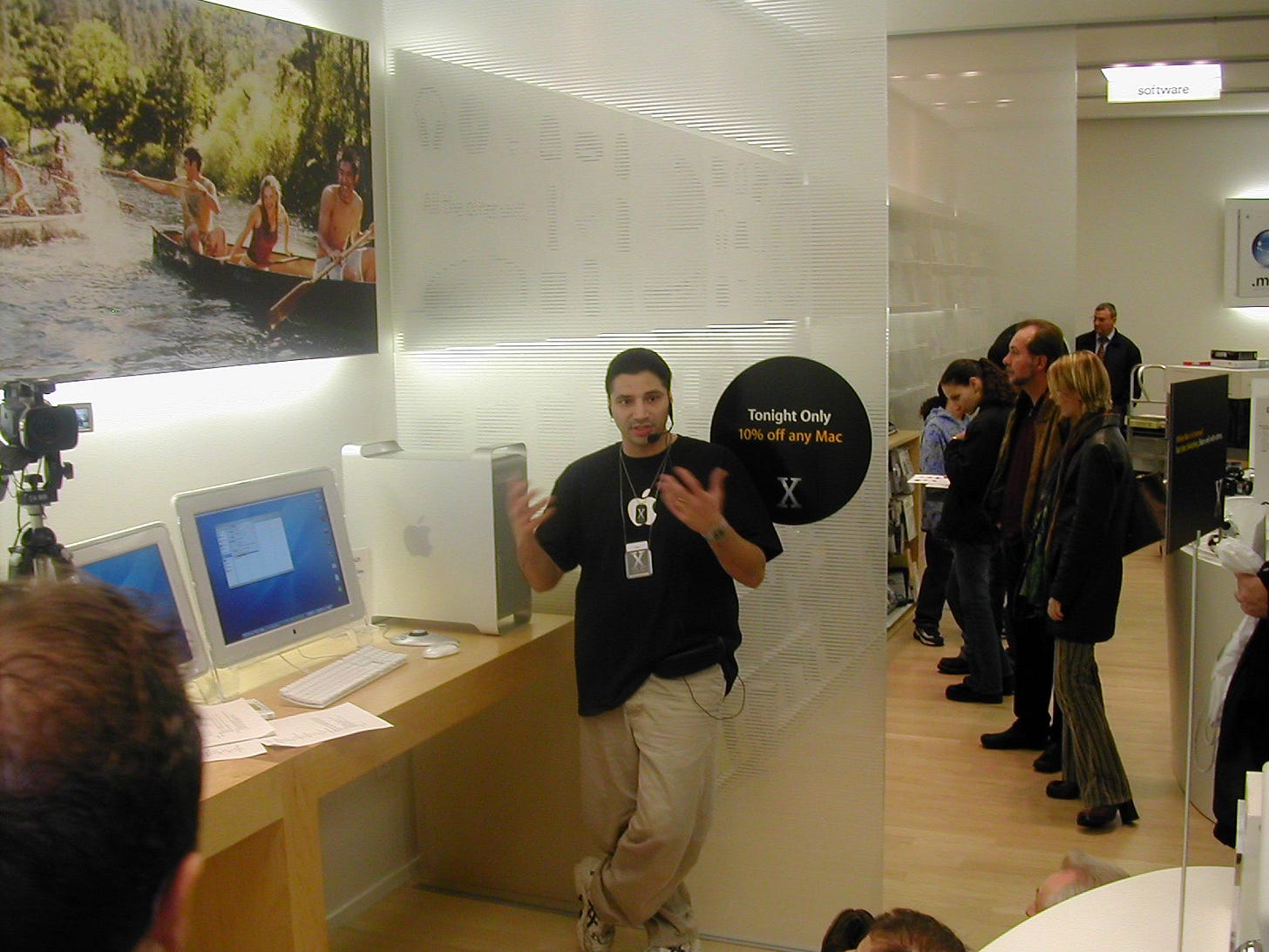 An Apple Store employee demonstrates Mac OS X during Night of the Panther.
