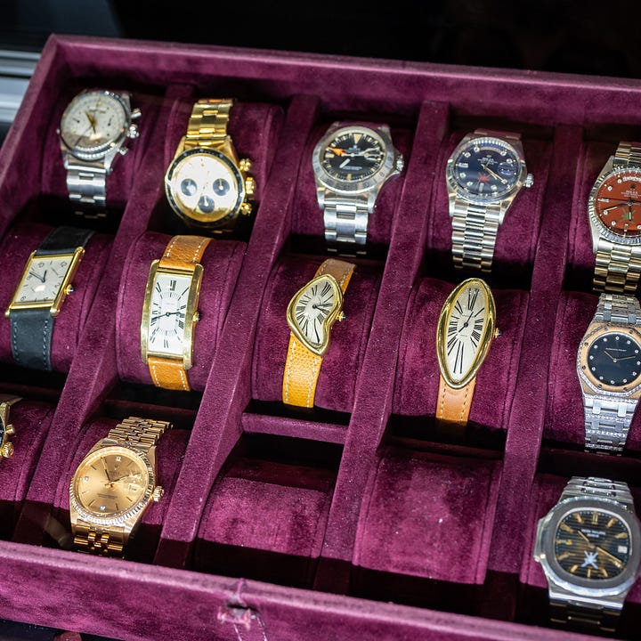 Pile of vintage gold Rolex and Cartier watches