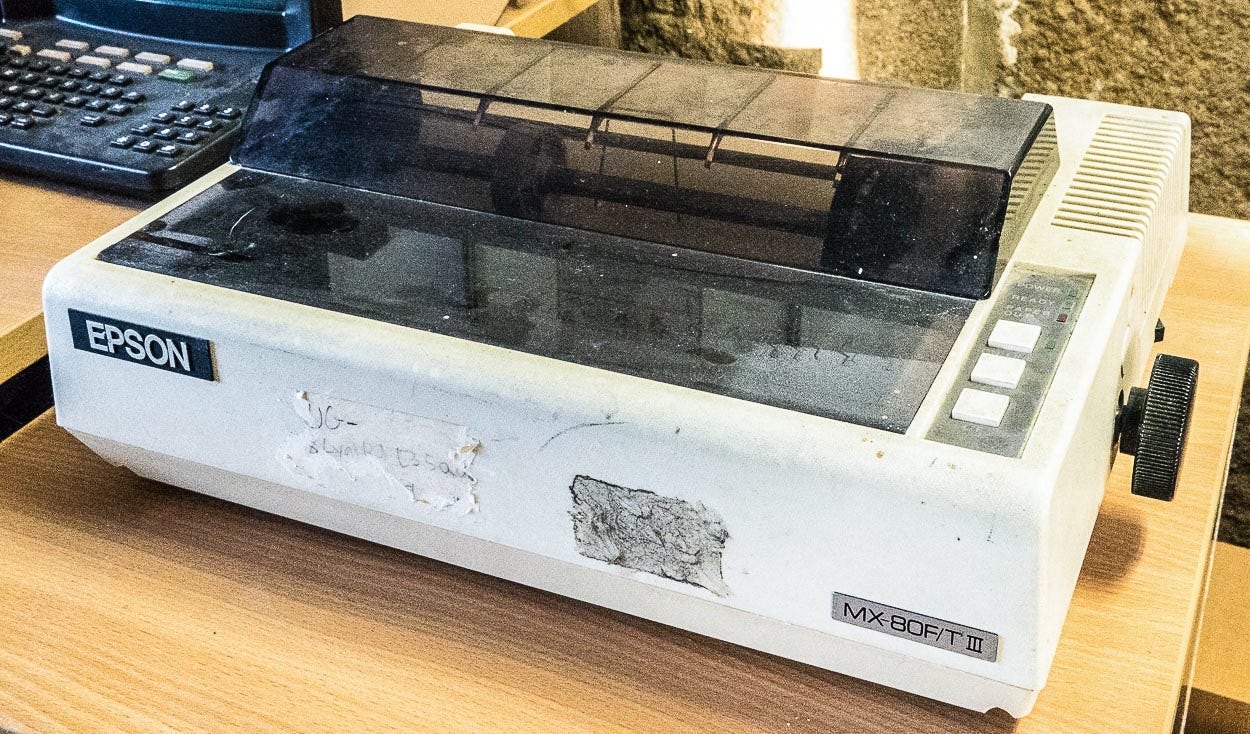 Photograph of an old and somewhat shoddy Epson dot matrix printer.