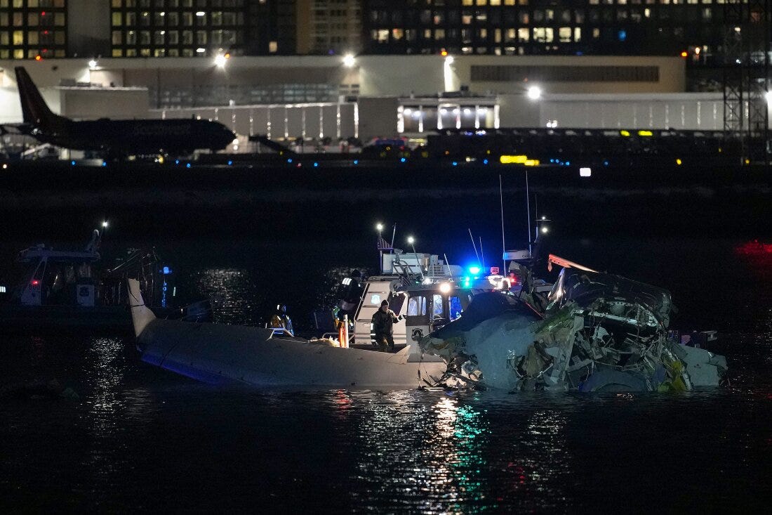 Emergency response units access airplane wreckage in the Potomac River near Ronald Reagan Washington Airport early Thursday in Arlington, Va., after an American Airlines flight from Kansas collided with a helicopter while approaching the airport. Emergency response units access airplane wreckage in the Potomac River near Ronald Reagan Washington Airport early Thursday in Arlington, Va., after an American Airlines flight from Kansas collided with a helicopter while approaching the airport.