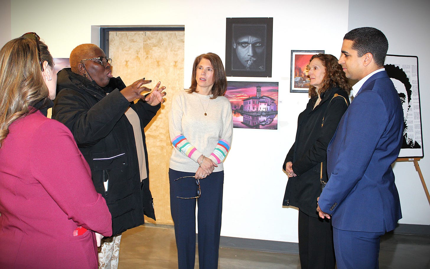 Nash Correctional Institution officer Markell Mitchell, second from left, talks about the art classes and art club she oversees at the facility. From left are Talena Lee, warden at Nash Correctional Institution; Mitchell; North Carolina first lady Anna Stein; Gerda Stein, Gov. Josh Stein’s sister; and N.C. Rep. Dante Pittman. Stein visited Wilson Arts to view the Nash Correctional art exhibit and find out more about its art program and how it benefits the inmates. 