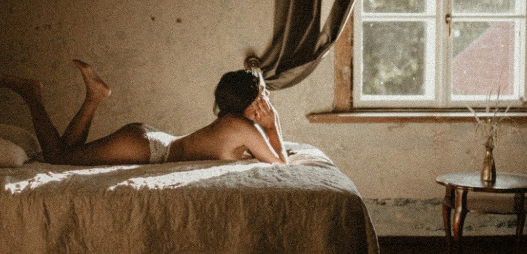 woman lying on bed near window woman lying on bed near window