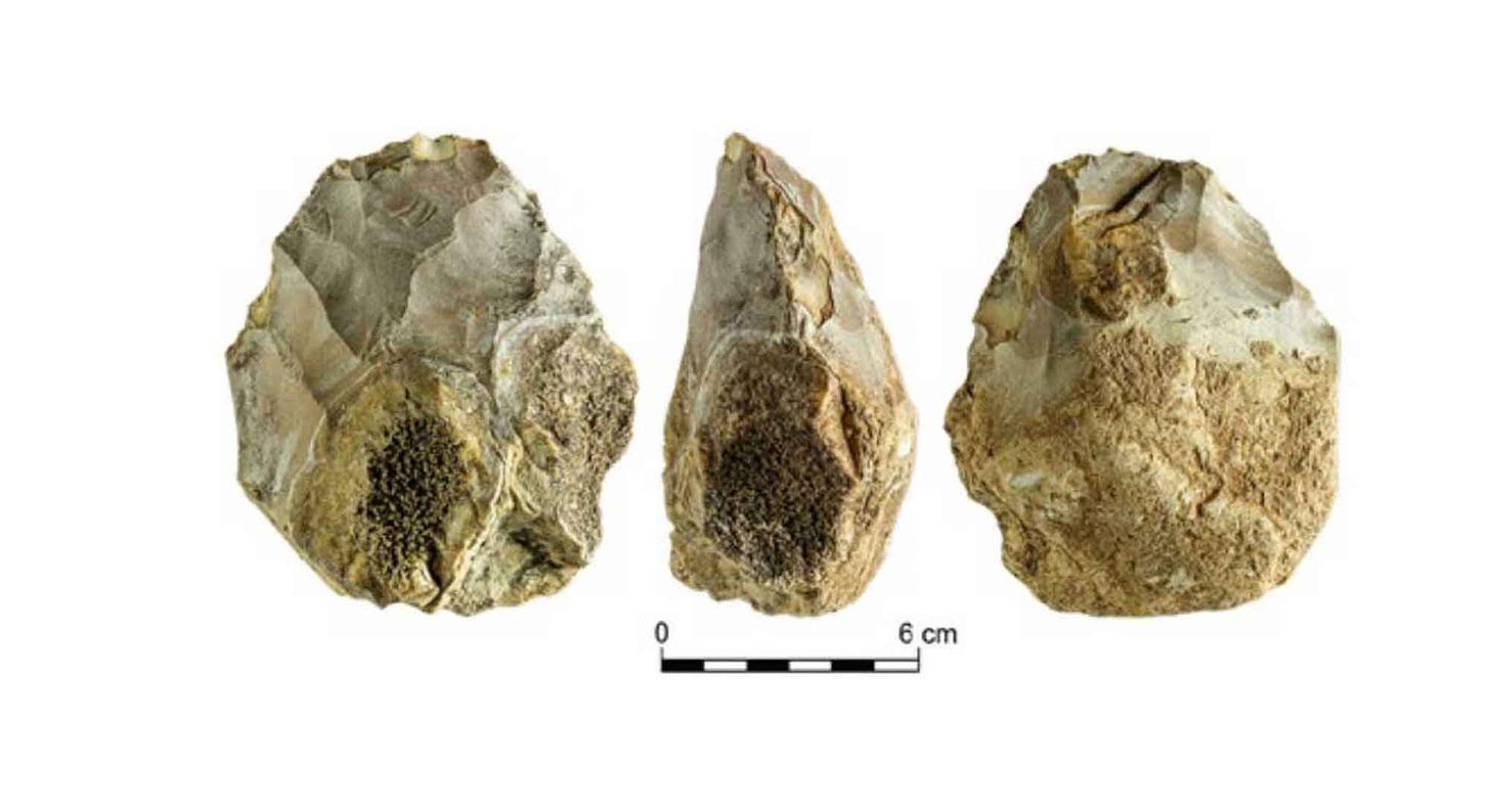 Handaxe with portions of two geodes visible
