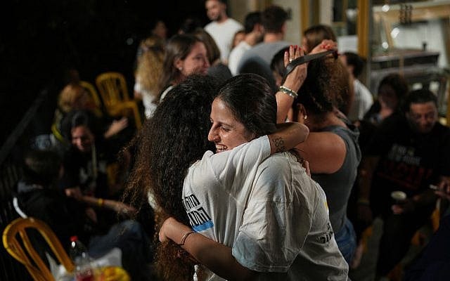 Relatives and supporters of Israeli hostages held by Hamas in the Gaza Strip celebrate after the announcement that Israel and Hamas have agreed to the first phase of a plan releasing the hostages and ending war in Gaza, in Hostages Square in Tel Aviv, Israel, Thursday, Oct. 9, 2025. (AP/Emilio Morenatti)