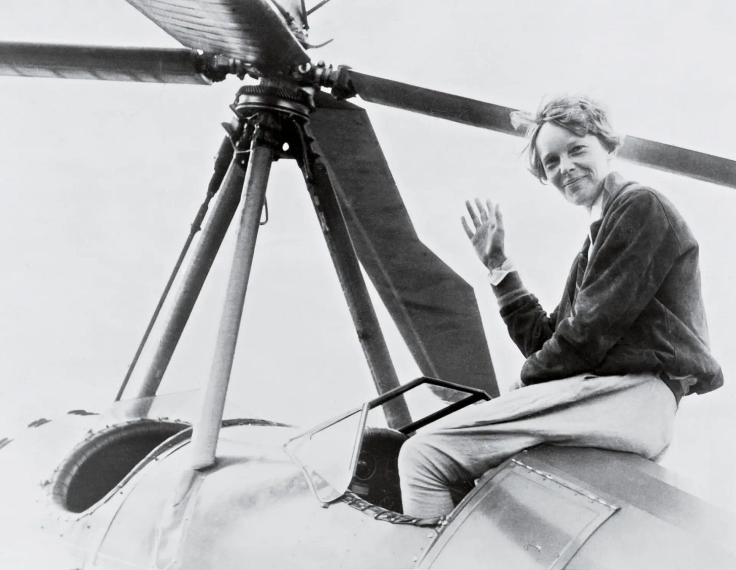 Amelia Earhart sitting atop what looks like an early helicopter
