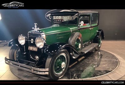 A green car on a black surface

Description automatically generated
