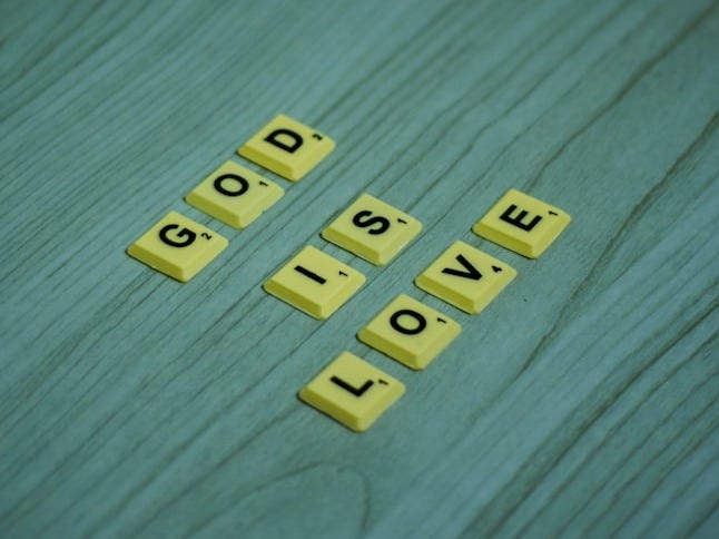 the word love spelled with scrabbles on a wooden surface the word love spelled with scrabbles on a wooden surface
