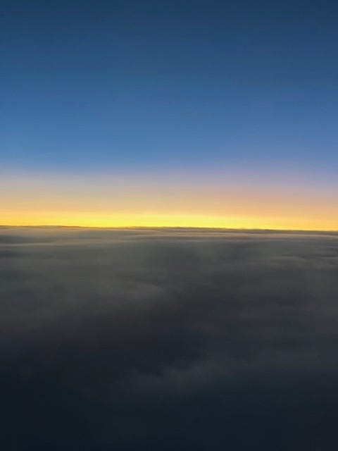 Yellow horizon of light against the clouds with blue above