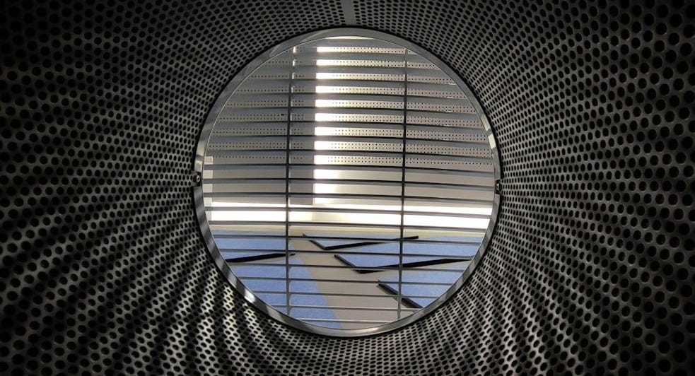 an airplane is seen through a circular window an airplane is seen through a circular window