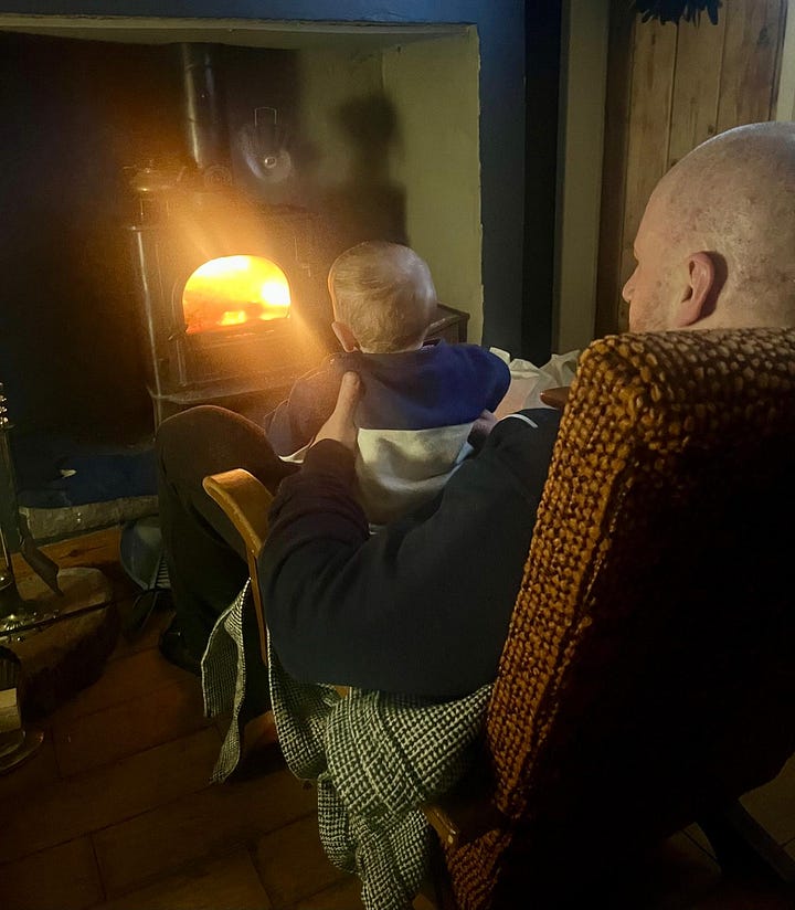 Left: Adam in firefighter gear. Right: Adam sitting beside a glowing wood stove with his young son, Marcus.