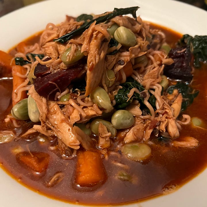 2 different bowls of soup - one with carrots & lentils, the other with chicken, noodles and vegetables