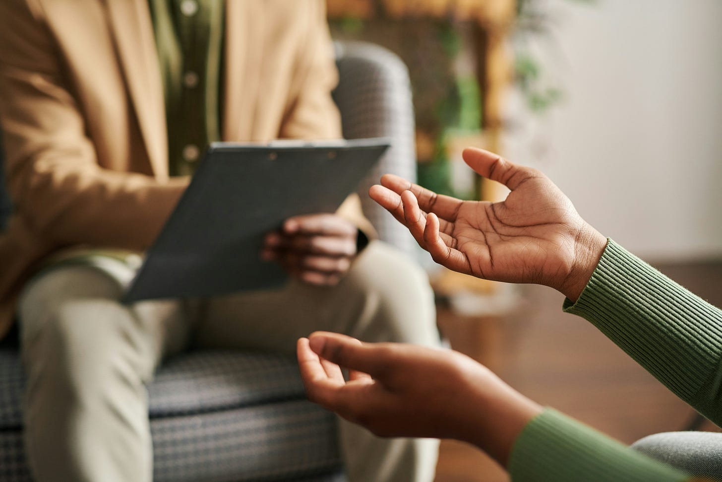 Photo of hands of an African American woman gesturing in a counselor's office