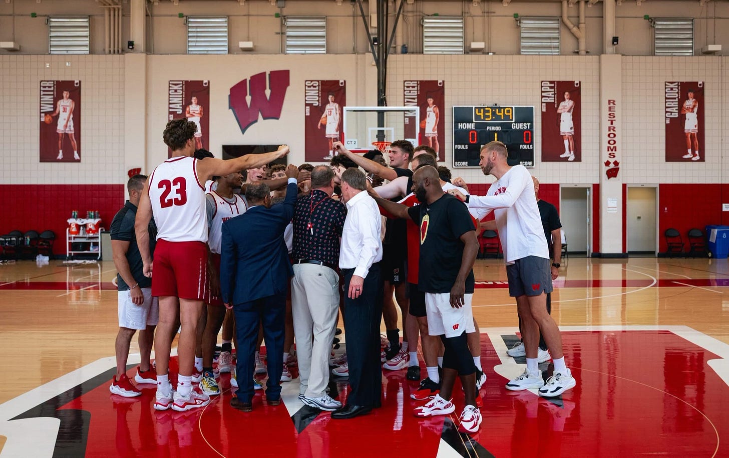 Wisconsin men’s basketball players and coaches gather in a team huddle at the conclusion of practice. Wisconsin men’s basketball players and coaches gather in a team huddle at the conclusion of practice.