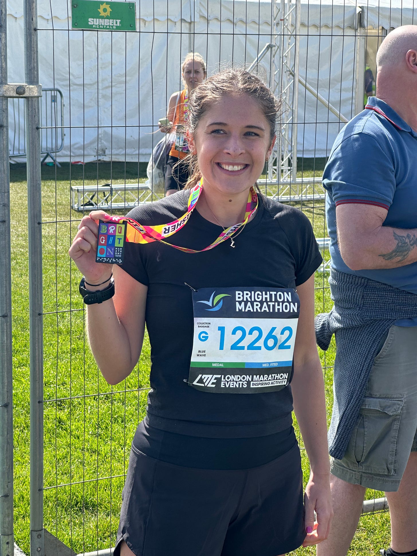 Me smiling after Brighton Marathon holding up a medal Me smiling after Brighton Marathon holding up a medal