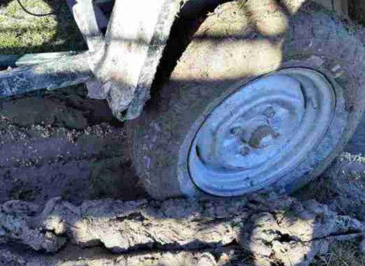 Farm truck wheel bogged in mud) Farm truck wheel bogged in mud)