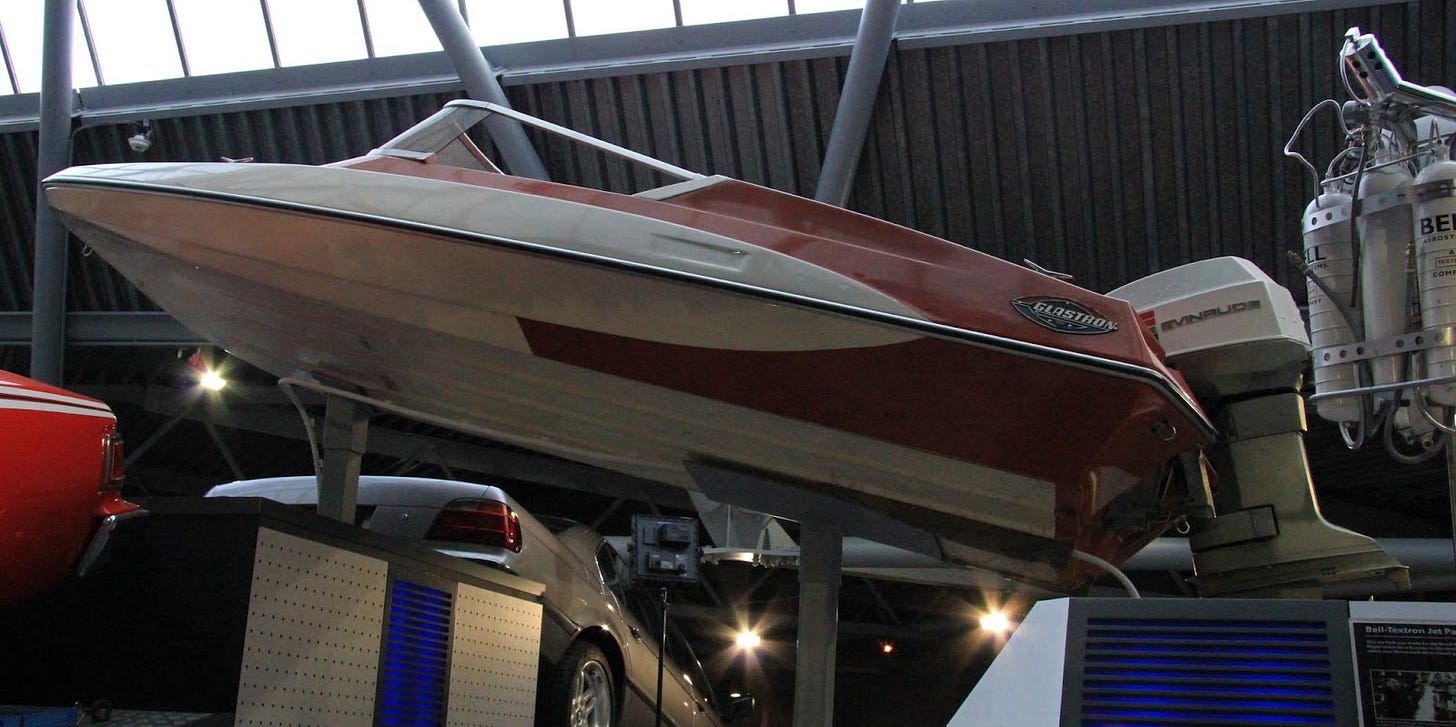 A red and white speedboat is raised on a platform to view it from many angles. A red and white speedboat is raised on a platform to view it from many angles.