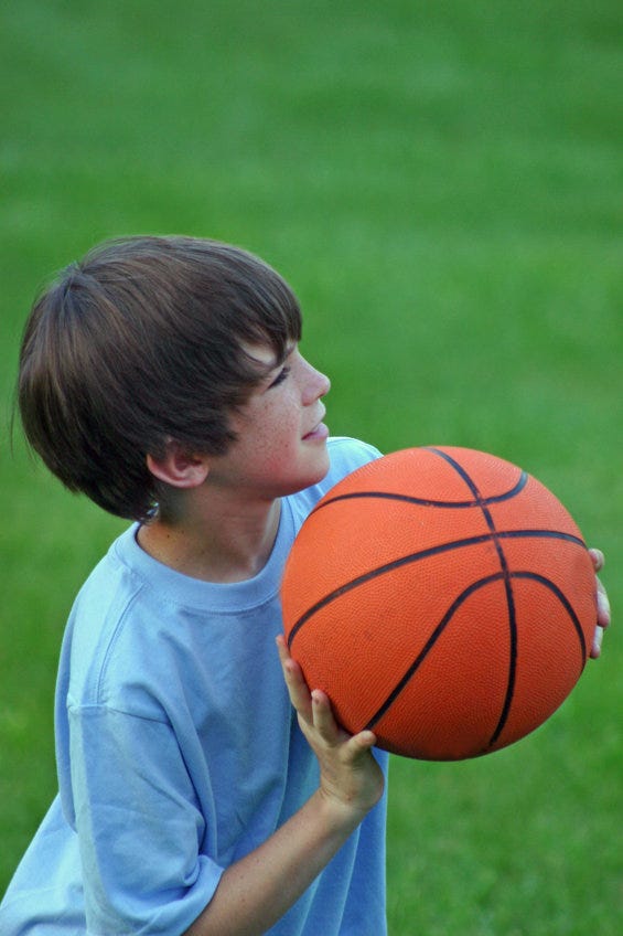 Boy shooting a basketball