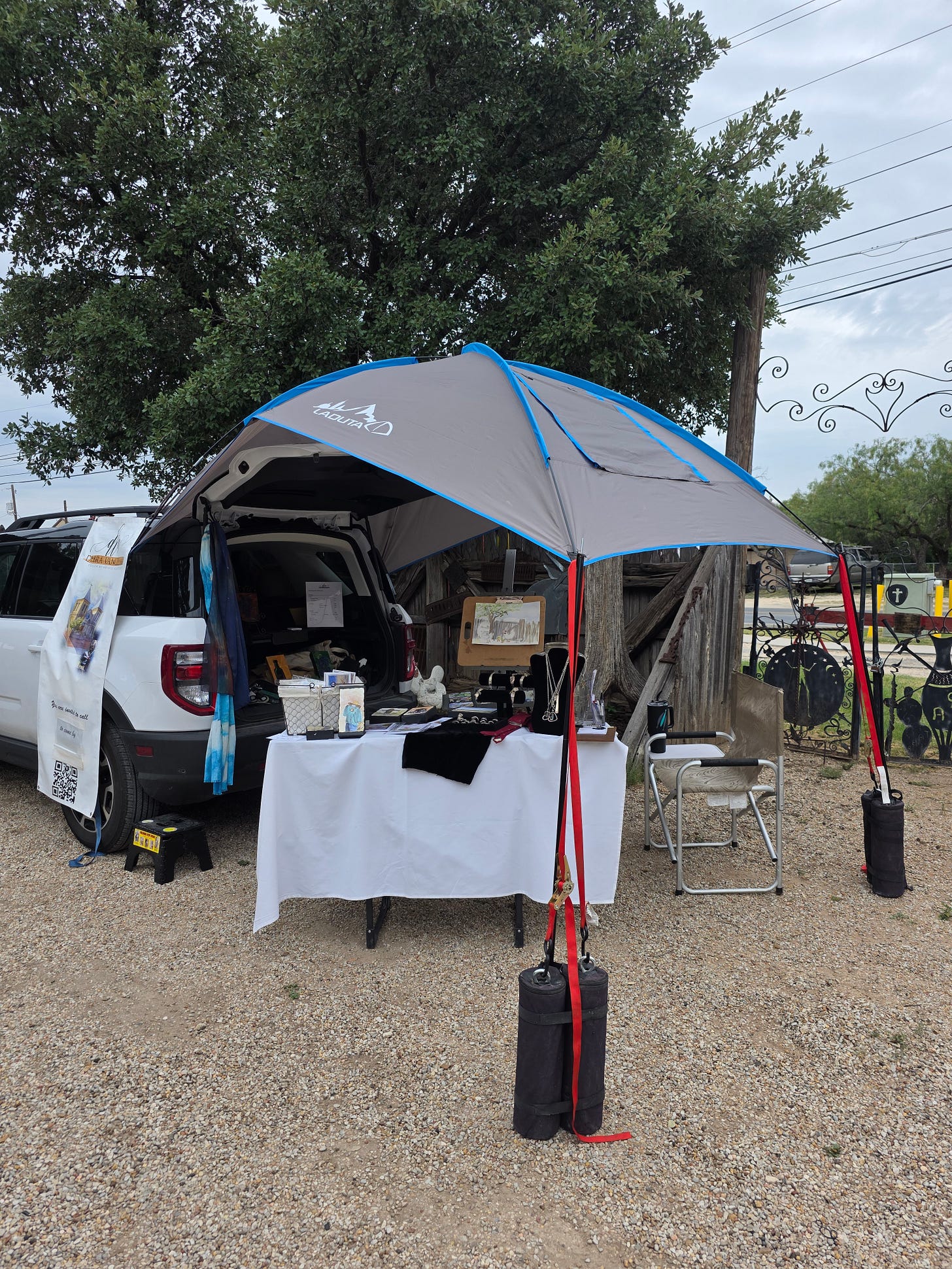 Debra Vance's Art - set up at the Chicken Farm Art Center for their 1st Saturday event. 08-01-26. Bronco Sport with a vendor booth display. 