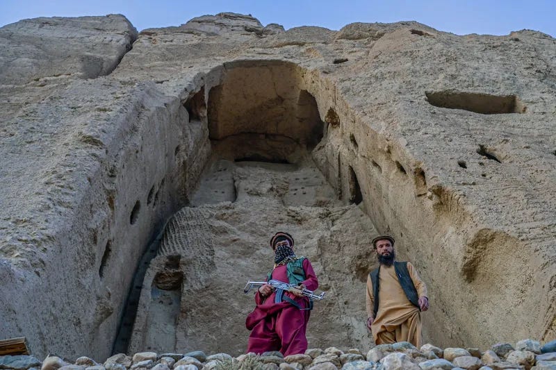 Members of Taliban stand in front of the site where the Shahmama Buddha statue once stood before being destroyed in Afghanistan. Members of Taliban stand in front of the site where the Shahmama Buddha statue once stood before being destroyed in Afghanistan.