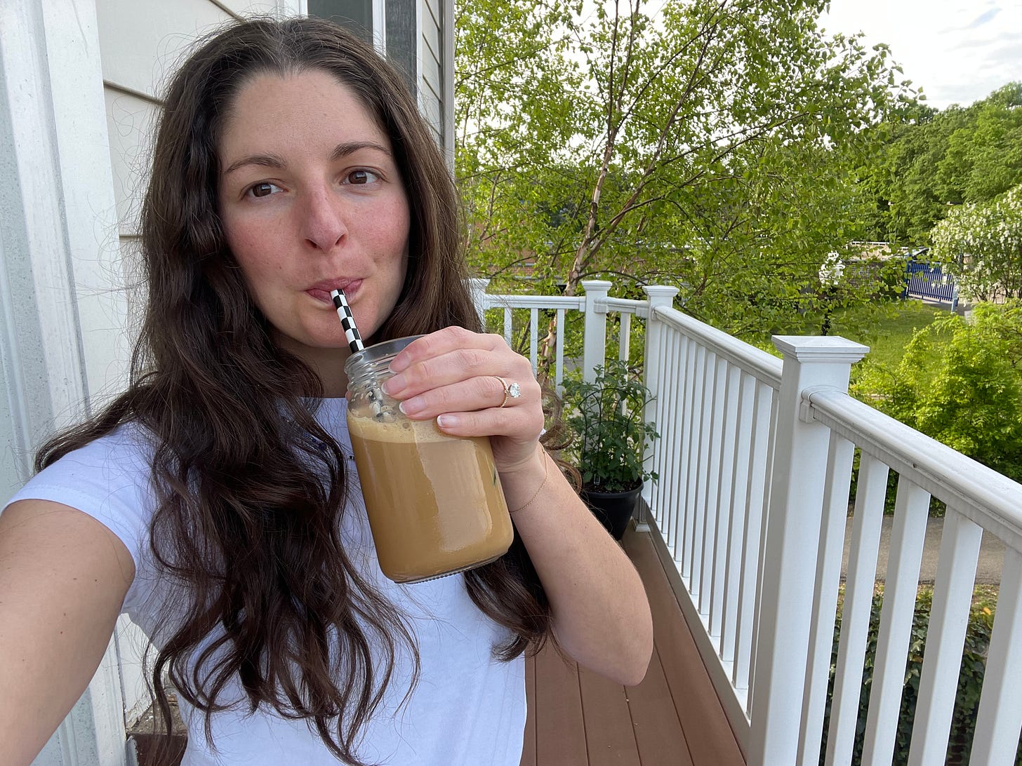 A selfie of Bianca drinking her signature iced coffee.