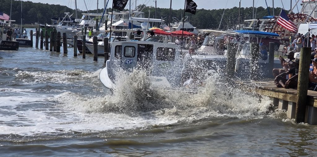 A boat sends water over the stern during the Taylor’s Island Boat Docking Contest.